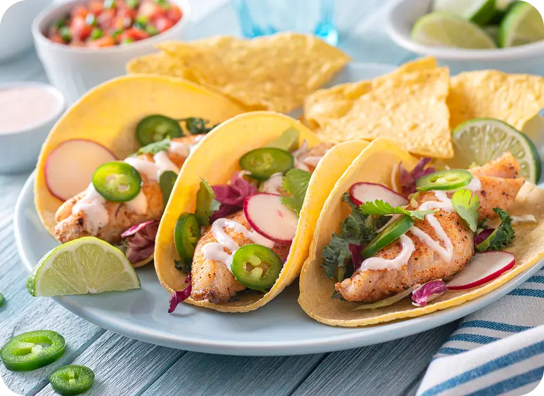 Fish tacos with toppings and tortilla chips